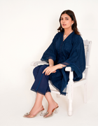 Model in navy blue chikankari embroidered lawn kaftan set with lace placket and cotton bell bottom pants by Emeralds