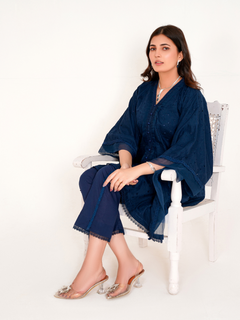 Model in navy blue chikankari embroidered lawn kaftan set with lace placket and cotton bell bottom pants by Emeralds