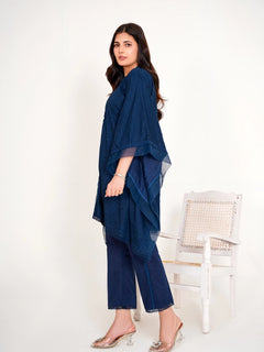 Model in navy blue chikankari embroidered lawn kaftan set with lace placket and cotton bell bottom pants by Emeralds