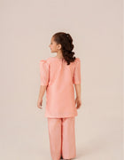 Little girl wearing Peach Blossom hand-painted peach dress from Emeralds Kids Collection