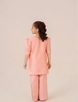 Little girl wearing Peach Blossom hand-painted peach dress from Emeralds Kids Collection