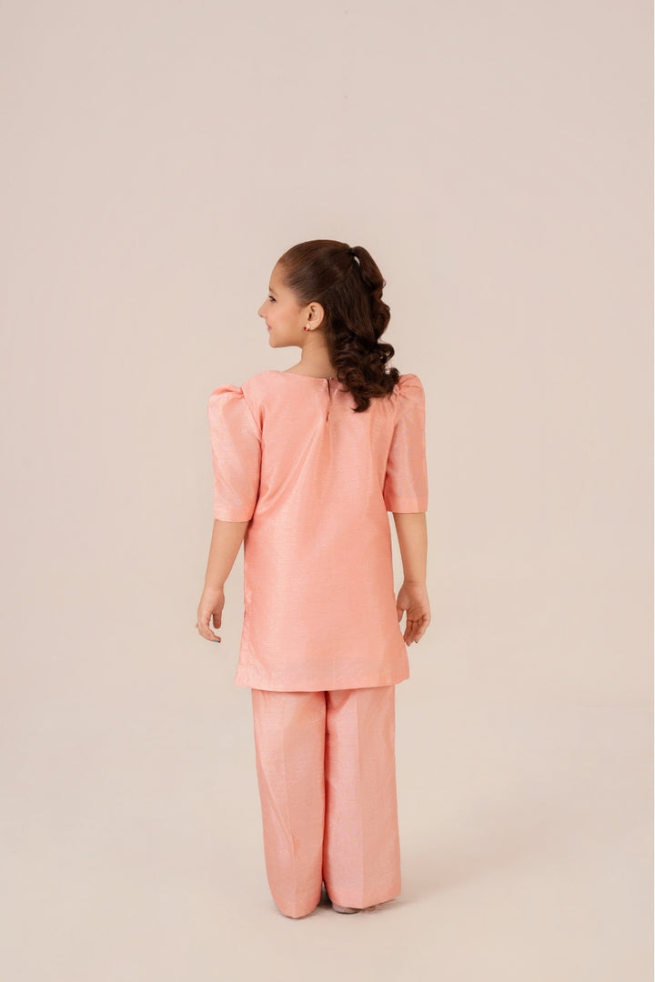 Little girl wearing Peach Blossom hand-painted peach dress from Emeralds Kids Collection