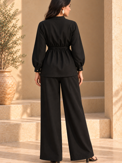 Back view of ONYX black Khaddi two-piece set showing gathered shirt waist and wide-leg fit