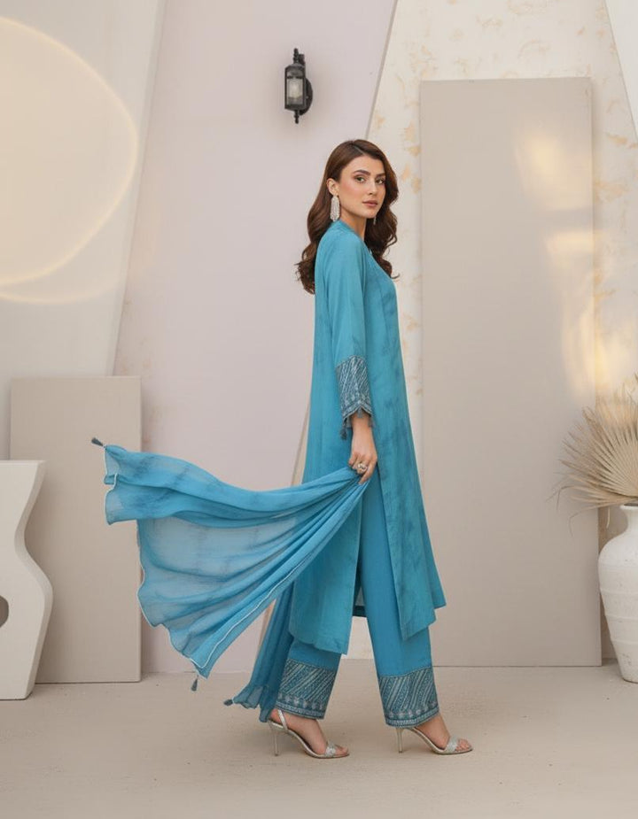Model wearing Emeralds “Dream Catcher” — an aqua blue embroidered raw silk 3-piece set with silver detailing and Silk dupatta.