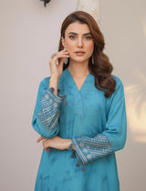 Model wearing Emeralds “Dream Catcher” — an aqua blue embroidered raw silk 3-piece set with silver detailing and Silk dupatta.