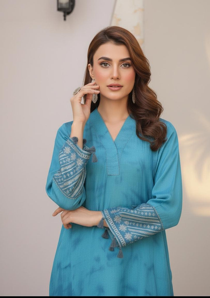 Model wearing Emeralds “Dream Catcher” — an aqua blue embroidered raw silk 3-piece set with silver detailing and Silk dupatta.