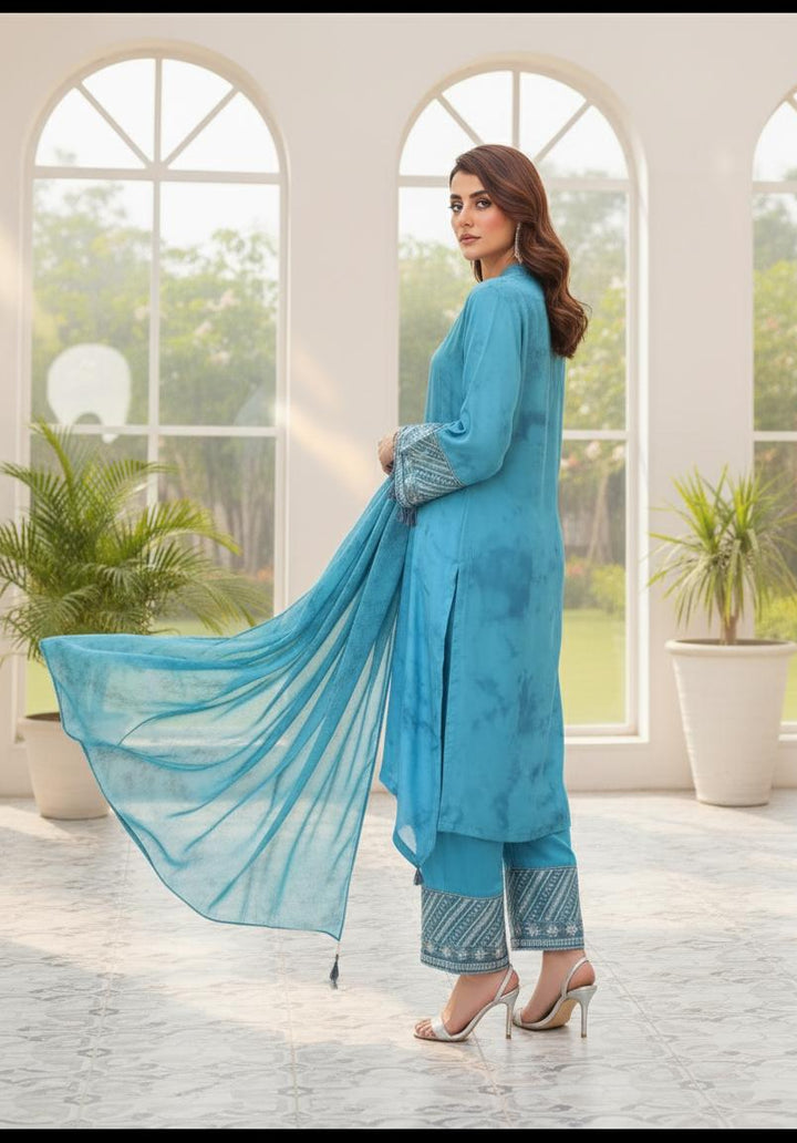 Model wearing Emeralds “Dream Catcher” — an aqua blue embroidered raw silk 3-piece set with silver detailing and Silk dupatta.