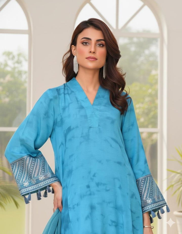 Model wearing Emeralds “Dream Catcher” — an aqua blue embroidered raw silk 3-piece set with silver detailing and Silk dupatta.