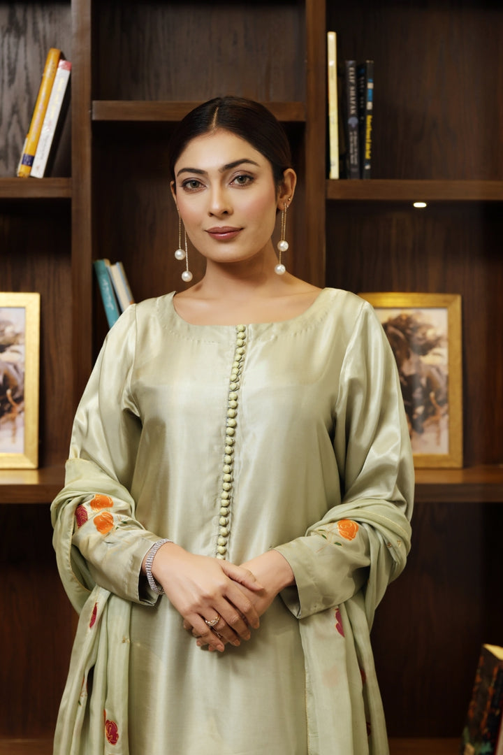 Model wearing stitched pistachio green pure silk outfit with hand-painted full-length shirt and embellished silk dupatta – front, side, and detail views.”