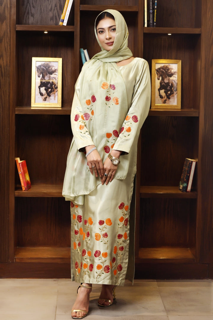 Model wearing stitched pistachio green pure silk outfit with hand-painted full-length shirt and embellished silk dupatta – front, side, and detail views.”