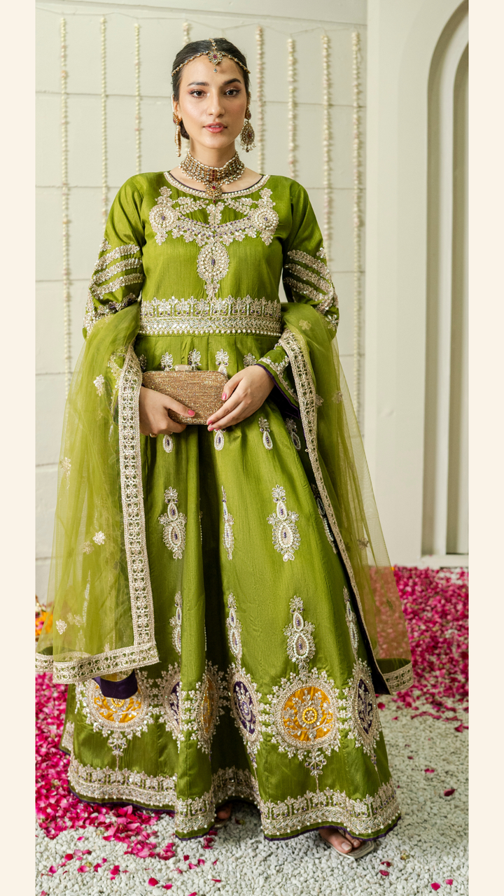 Woman wearing an olive green raw silk maxi with heavy embroidery and net dupatta

Close-up of tilla and pearl hand embroidery on green raw silk fabric