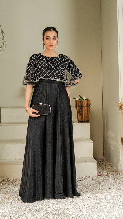 Model wearing Casanova black moonlight maxi dress with diamond-embellished net cape, styled for formal and festive evening wear.