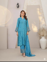 Model wearing Emeralds “Dream Catcher” — an aqua blue embroidered raw silk 3-piece set with silver detailing and Silk dupatta.