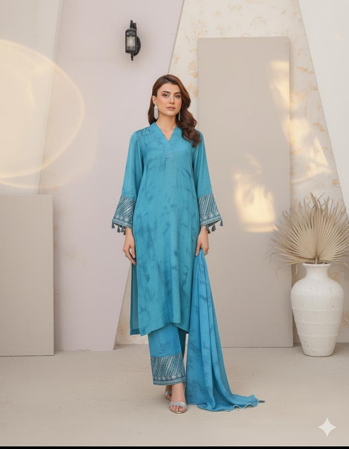 Model wearing Emeralds “Dream Catcher” — an aqua blue embroidered raw silk 3-piece set with silver detailing and Silk dupatta.