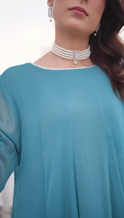 “Model wearing a flowing ocean blue embroidered chiffon frock with silk dupatta – front, side, and seated views for a formal traditional look.”